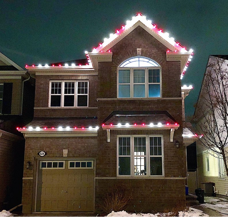 Brick home with classic red-and-white roofline lights