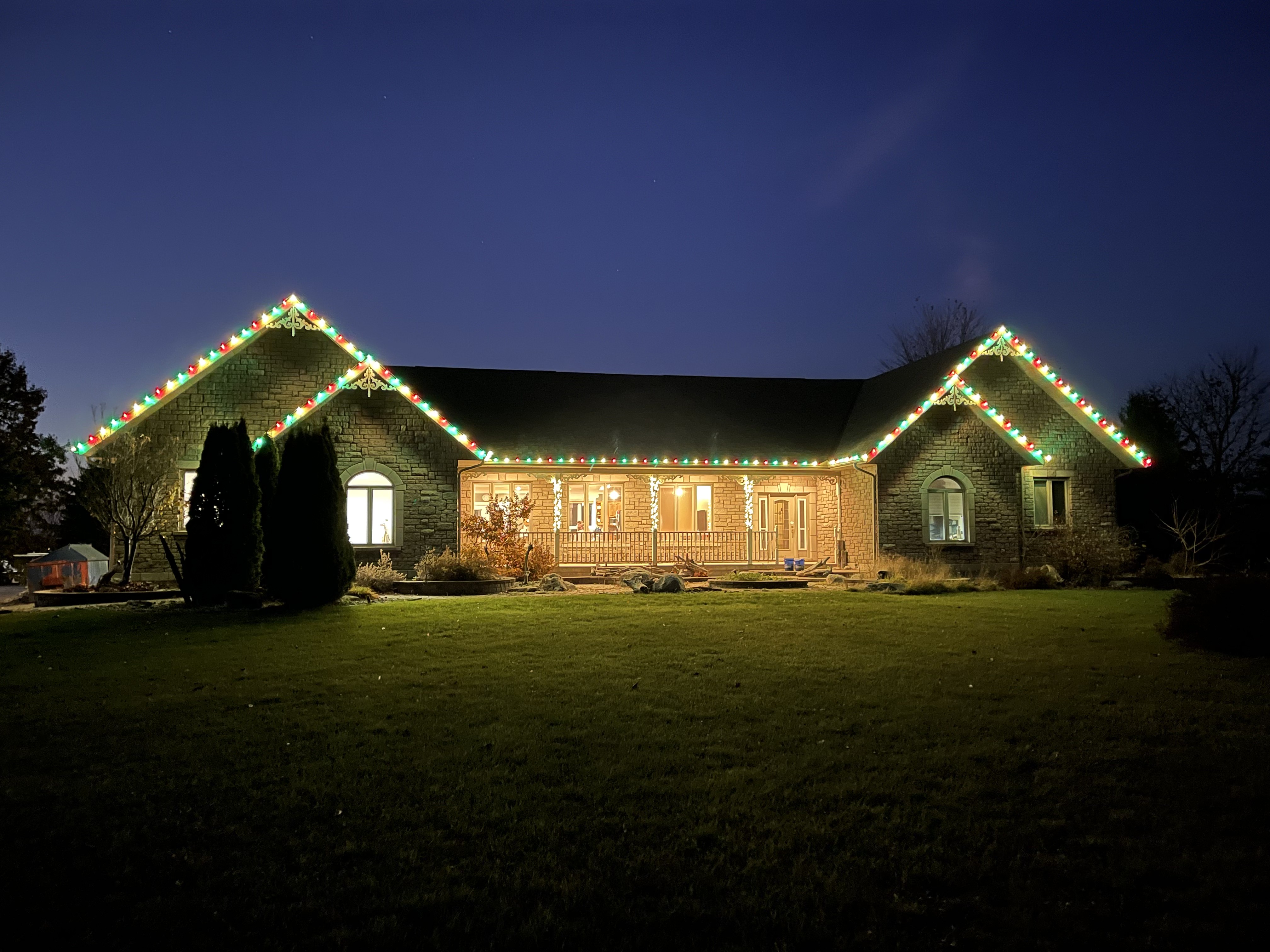 Stone ranch with a full-color roofline display